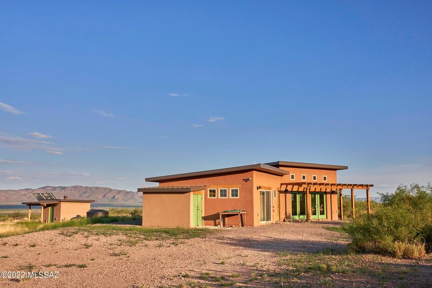 Price Reduction!  The Artist's Getaway is off grid and turn key furnished home on 40 fenced acres with a breathtaking view of Sulphur Canyon. Designed and built by owners to allow for expansion.  360 views of Chiricahua Wilderness, Peloncillo Mtns & San Simon valley. 4400' elevation sloping grasslands, scattered oaks & mesquites.  Imagine taking an outdoor shower and roaming the rock labyrinth with a beautiful Sulphur Canyon Backdrop.  Insulation Ceiling-R38 Walls R28 Area is a favorite with astronomers for its clear dark skies. In addition Cave Creek Canyon is world renowned for birding.  Rodeo NM & Portal AZ offering cafes, post offices, art galleries, medical clinic & library. Major shopping & hospital 50 miles south in Douglas.