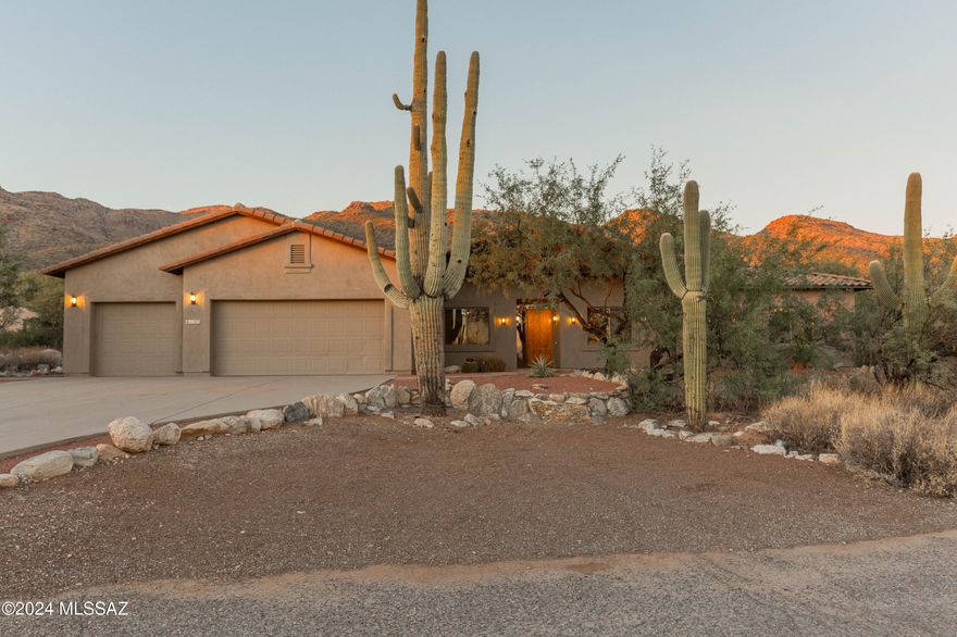 Welcome to your serene oasis! This delightful ranch-style home is perfectly situated at the base of the breathtaking Catalina Mountains, offering panoramic vistas views and a tranquil atmosphere. This home is situated on 3.3 acres in a peaceful & private custom home neighborhood, surrounded by acres of natural beauty and tranquility of the desert while being just minutes away from outdoor adventures.
Upon entry you are invited to an open-concept layout with large windows that bring in natural light and showcase mountain views. Exposed soaring wood beamed ceilings add dramatic architectural detail that adds warmth and character to the spacious living areas. Spacious kitchen features granite counter tops, oak cabinets, gas stove, stainless steel appliances, ample storage.... and plenty of space for entertaining. Upon entry sits another bonus room with beautiful glass french doors that would be perfect for an office or library. Primary suite features an en-suite bathroom with dual vanities, a soaking tub, walk-in closet and a fireplace.. perfect for warm ambiance while enjoying more mountain views. Additional four well-appointed bedrooms provide ample space for family and guests and bonus room is ideal for a home gym, playroom, media room,or in-law suite complete with 4th bedroom attached and bath. Finally, this stunning backyard is an outdoor paradise! This expansive outdoor space features a sparkling pool with spa nestled under the captivating views of the mountains, expansive wood beamed porch, pool bathroom/powder-room, outdoor stone fireplace, soaring saguaros and lush surrounding desert...perfect for relaxation and gatherings. No HOA allows for RV parking, extra acreage allows for expansion. Brand new tile Roof Installed October 24, providing durability and style. And freshly painted full exterior and full interior paint, giving the home a refreshed look. Don't miss your chance to own this incredible Tucson ranch home, where luxury meets nature!