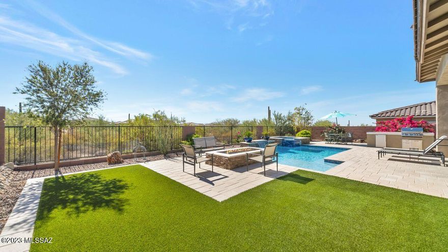 Beautifully appointed Artesa plan at gated Blue Agave II. Courtyard space welcomes you to the foyer, which opens to spacious great room, dining & kitchen with stunning patio views from wall of sliders! Custom media cabinet anchors the great room. Custom lighting. Large island w/ seating, gas cooktop w/ stainless hood. Pantry closet & custom bar off kitchen. Tranquil owners suite w/ plenty of windows, walk-in shower w/ dual shower heads, 2 sinks plus makeup area, custom closet! Bedrooms 2 & 3 w/ Jack & Jill bath between. Den, half bath, laundry w/ sink & cabs complete this home. Backyard oasis featuring spacious covered patio,  Pool (ultraviolet filter), spa w/ waterfall, fire feature. built in BBQ & fridge. 3 zone heat & cooling. Separate 3rd car gar. Call for private showing !