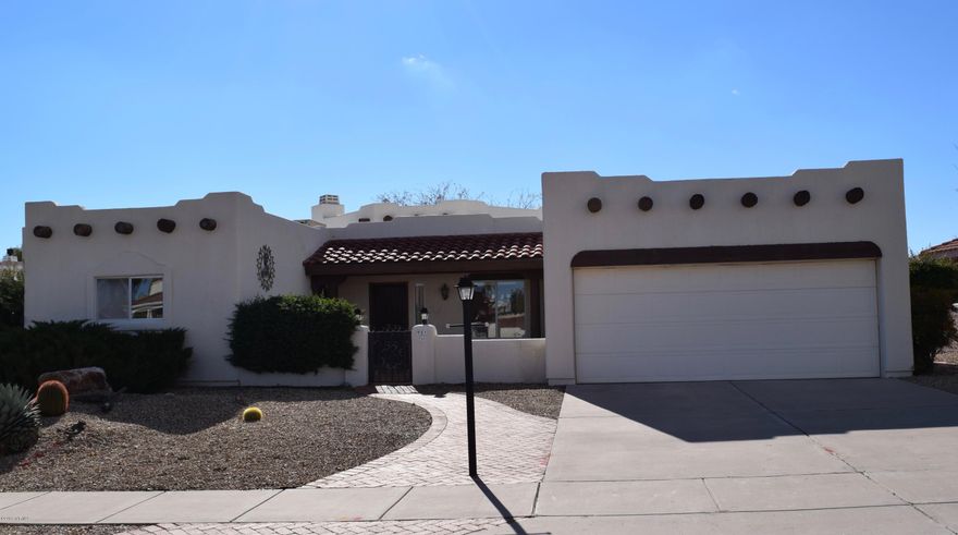 Custom home on a large lot with mountain views.  Open floor plan with high ceilings, wood beams, wood burning  fireplace, 3rd bedroom can function as a den or bedroom with double pocket doors.  Master bedroom has walk-in closet, slider to patio, and den/office area. Kitchen has views off the window above the sink and off the large nook.  Front courtyard entrance.  Rear covered patio has roller shades, beams, and desert and mountain views.  Garage has lots of storage and epoxy floor.   A great home to enjoy the Arizona lifestyle both inside and out.