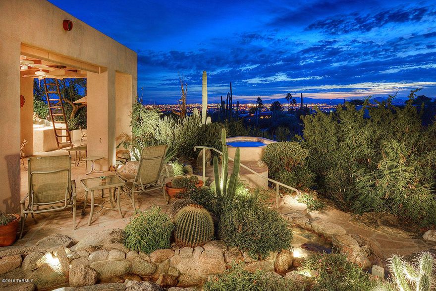 Enjoy spectacular city lights and sunset views from this custom southwest home in Finisterra. A private setting and foyer invite you into this wonderful spacious split floor plan that offers high ceilings and plenty of natural light. Bedroom #2 is ensuite, great for guests or visitors, piano/wine room off the great room has wet bar and entertaining space. Charming kitchen has double ovens and is open to family room with cozy fireplace. Fabulous outdoor living in back yard with spa and peaceful stream. One owner home and has been well maintained.