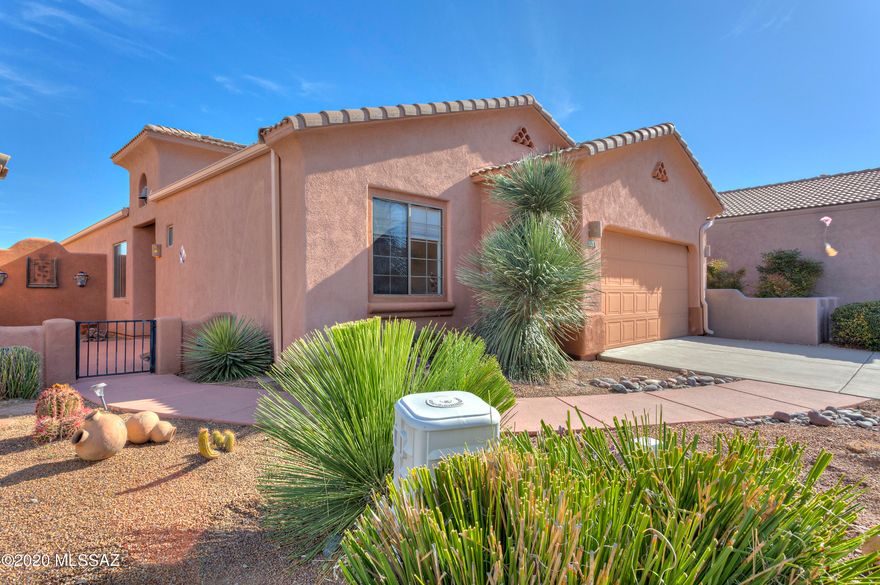 The serene entry courtyard is accentuated by the bell tower in this lovely home in the desirable Legends community. Upon entering the foyer, the posts and corbels draw you into the great room with gorgeous mountain views of the Santa Ritas. This split bedroom design is ideal when accommodating guests providing them privacy and ample quarters. Mexican tile accents the doorway into the large kitchen and provides the backsplash for the gorgeous birch cabinetry and an abundance of countertop space to have several chefs in the room at the same time. The wooden beams and space above the cabinets draw your eye to the high ceilings. The breakfast bar keeps guests close, yet out of your way. The great room provides space for formal dining, a fireplace to warm up on those cool winter nights, Beautiful southwestern cornices with copper inlay lead the way to the large screened in porch perfect for watching the Santa Ritas turn pink. A generous sized den rounds out the living areas. The owner's suite has a large walk-in closet and bath with both a soaking tub and separate shower. The mirrors above the double vanity are framed in stunning mesquite adding texture and a sense of opulence to the room. This home is fully furnished and ready to move in. Enjoy all the amenities that Green Valley has to offer.