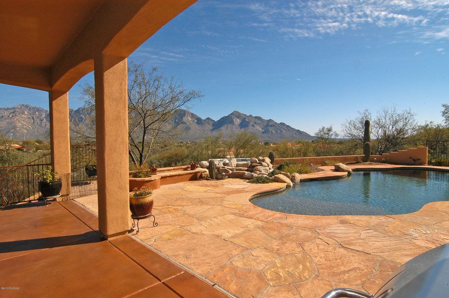 Arizona ''La Casa'' on 3.3 acre private homesite. $60,000 redux + breathtaking mountain views form a backdrop for the pool/spa, 2 grand patios accenting home's entertaining flair. Located at the end of long driveway off cul-de-sac,  arched entry is flanked by classic tower. La Casa features 4 bdrms/4 baths + den. Guest wing has semi-private in-law bedroom and en-suite bath with roll-in shower. Third bdrm also has private bath. Luxurious bath in master with pool access door and sep. laundry. Custom designed kitchen features granite peninsula surrounding an island w/warming drawer. Designer cabinets and appliances, beverage frig, and pantry w/pull-outs complete it. Formal living & dining and huge family room w/FP invite entertaining. Special sunken outdoor FP & lawn and 3-car garage w/storag