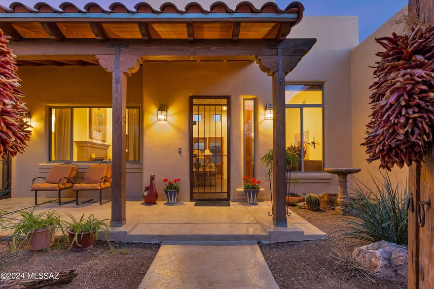 Rare opportunity at the Garrison in Valley Ranch on the Old Fort Lowell Corridor. A charming courtyard entrance invites you into this beautiful Territorial style home. The many lovely features include 2675 square feet, 3 bedrooms with en suite bathrooms plus a powder room, split bedroom floorplan, living/dining room combination, scored concrete floors throughout, large kitchen/family room combination with custom built entertainment center. The Cook's kitchen features 48'' Viking Gas Range with 6 burners and a griddle, refaced cabinets, custom hutch, quartzite countertops, and new tile backsplash. The zoned HVAC units are 3 years old. There is a generous covered back patio with scored concrete floors, well maintained pool and dog run. Dining Chandelier,Washer/Dryer do not convey.