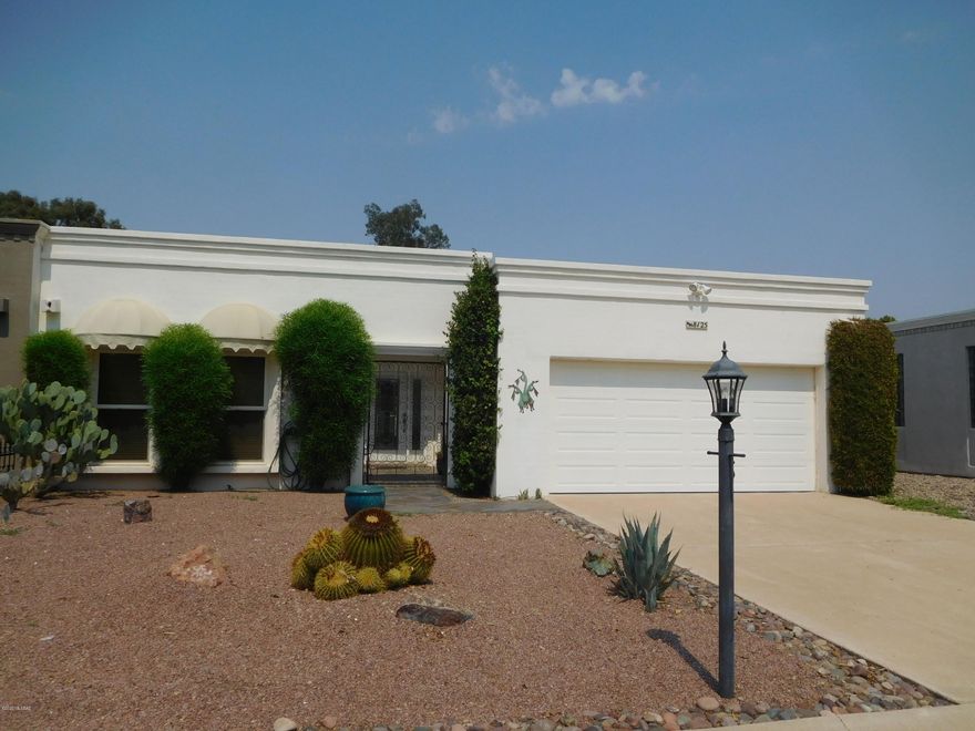 Tucson gem in the heart of Omni Tucson National Golf Course Resort!  On the 13th Hole, backs to former Audubon Bird Sanctuary, this special home offers golf course living and privacy.  Gated 55+ active adult community with year round heated pool/spa.  Features many upgrades; light & bright with large living room, open floor plan, granite counters, appliances, solar tube, wood blinds, new windows, en-suite bath w/dual vanities.  3rd bedroom perfect for visiting grandchildren.  Beautiful front landscape, across from large grass park & pool area. Community has old-growth trees & wide open spaces. Located close to all amenities.  You'll feel like you've entered an oasis when you drive into this magical quiet neighborhood.