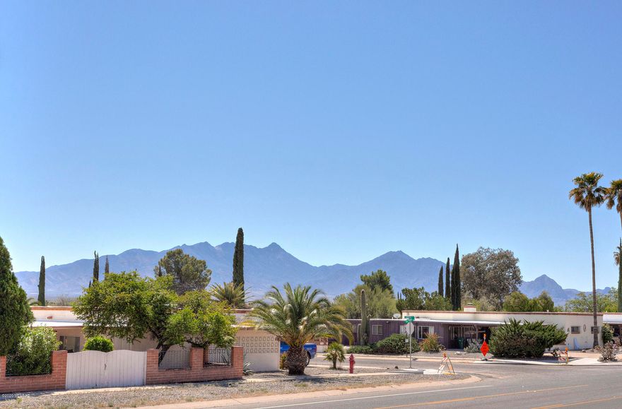 This charming and refurbished territorial sits on an elevated .23 acre lot and offers sunrise and mountain views from the bricked front patio, a covered side patio that provides ''private'' space for quiet times, and a rear patio where you can watch the desert sunsets! 
With laminate and tile floors throughout, this open concept gem provides room to entertain or cozy nights in front of the propane log fireplace.  Although too many to fully list, recent improvements include new windows, patio doors, ceiling fans, A/C, and water heater; upgraded electrical and plumbing fixtures; and a roof re-coat.  In addition, the huge rear yard has new chain link fencing that surrounds the entire back property and offers alley access and double gates to park all your toys!  Showings by appointment only.