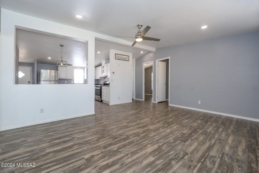 Charming move-in ready 3 bed/2 bath manufactured home on a .90 acre lot in the serene southwest side of Tucson. With no HOA restrictions, this property offers the ultimate freedom. Step inside to a spacious living room & open concept kitchen. The primary bedroom features a walk-in closet and ensuite shower, with a split bedroom floor plan that ensures extra privacy. New flooring was installed in October! New AC unit & bathrooms were updated in 2020. SS refrigerator conveys. The vast lot offers endless possibilities. Build your dream garage, or workshop, add a horse stall, and park your RV or boat. Soak in the mountain views, breathtaking sunsets, and natural desert landscape. 15-minute drive to the freeway, this property combines peaceful rural living with easy access to city amenities