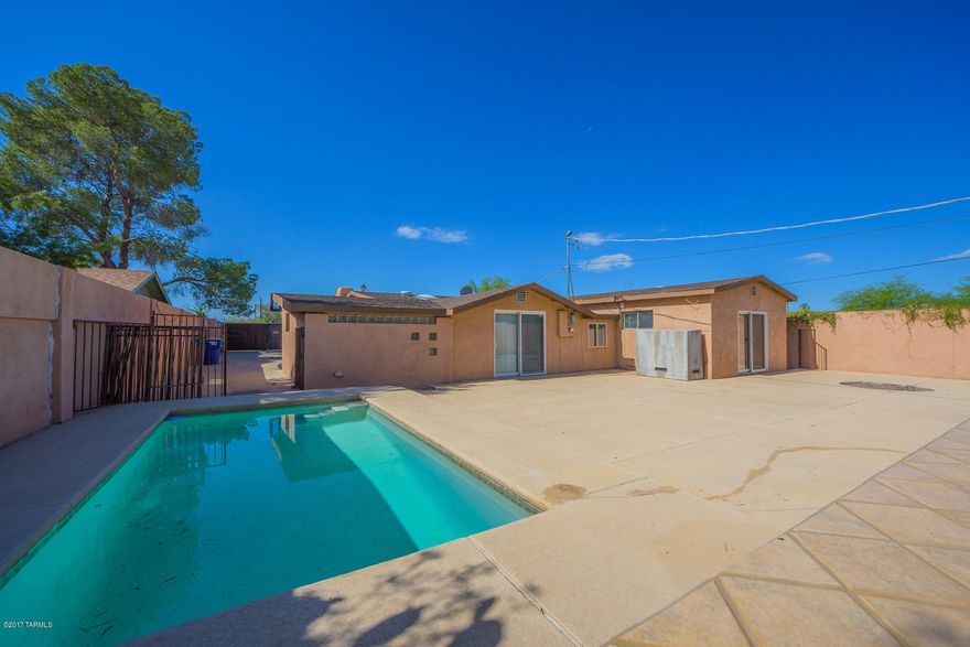 Private gated home near U of A with sparkling swimming pool! Built-in outdoor BBQ and storage shed (with electric outlets).  Tons of parking space! Home has been professionally cleaned. Kitchen includes new cook-top, and lots of counter space for cooking and entertaining. A cozy fireplace graces the great room. Laundry room includes washer and dryer. Spacious walk-in shower and custom cedar closet in master suite. Tiled throughout with carpet in bedrooms. Upgraded light fixtures. Low maintenance landscaping. A true paradise both inside and out!