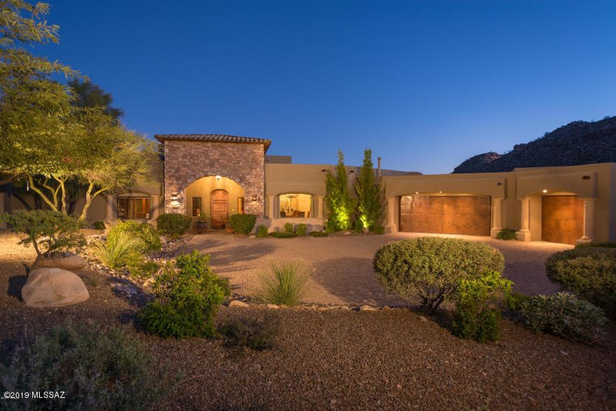 This Tuscan Villa welcomes you thru an archway leading to stunning entry porch. With 4550 sf (4094 main house, 456 guest qtr) you enter a foyer with Cantera columns that opens to Great Rm w/fireplace, floor to ceiling bookcases w/library ladder, entertainment cabinets, wall of windows & access to huge covered patio. Beautifully detailed kitchen with high-end amenities: Viking, Sub-Zero, Miele, Fischer & Paykel appliances, 120 bottle wine storage, wet bar w/under counter fridge & icemaker, cooktop on island, family dining area. Tray ceiling in the formal dining room, elegant chandelier. Huge master suite offers raised hearth fireplace, private office/gym, bath w/ raised jetted tub, large shower, dual sinks & large custom closet. 2 complete guest suites with private patio access... More... Secluded casita gives your guests privacy. Spectacular mountain & city views from the rear yard. Pool, spa, fireplace, outdoor kitchen, covered & open patio areas give you the resort living you have been looking for.