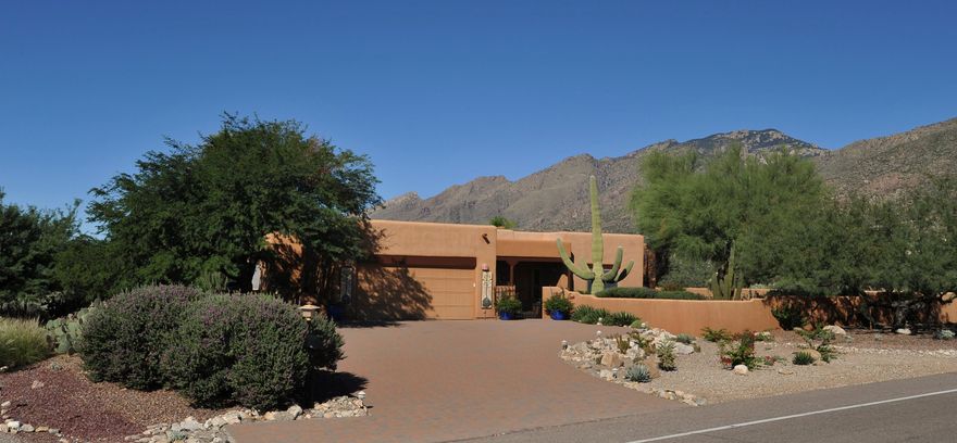 Panoramic Catalina Mountain Views! Located next to Sabino Canyon w/lots of privacy & stunning views! Charming courtyard w/fountain & extensive use of brick pavers wrapping around the house! Lg kitchen offers custom cabinetry, island & stainless steel appliances including built-in microwave & slide in gas stove w/double ovens. Features include Hunter Douglas blinds, Anderson windows & sliding glass doors plus built-in speakers in ceiling throughout. Spacious master suite has French doors & cozy FP. Gorgeous backyd w/grass area, beautiful Palm trees, additional Ramada over built-in BBQ area, patio features pavers & extensive aggregate around heated pebble-tec pool & spa. Lg concrete pad could be used for RV parking or basketball hoop! Oversized garage w/space for workshop or extra storage.