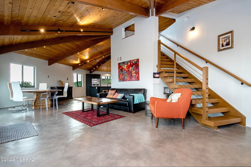 This special home, perched above Arizona National golf course, on over an acre, in the exclusive Sabino Estates was lovingly reimagined and fully re-designed with a modern aesthetic in 2021-2022. Some of the many upgrades include electrical, plumbing, floors, lighting, custom staircases, HVAC, window, gourmet kitchen, bathrooms (see full upgrade list in docs). A large primary suite is on the main floor, along with an open-concept kitchen, dining, and living space. Below is a basement that may easily be made into additional living space and/or a garage (partially finished.)  The top level boasts a loft that may be utilized  as a bedroom or den.  360 views of mountains, the city, and golf course may be seen through windows on every wall, allowing for ample natural light.