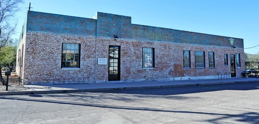 Repurposed warehouse located just north of downtown. Built in 1925 the double and triple brick structure has striking architectural features including a bow truss roof system and restored steel casement warehouse windows. 5,000 square feet of the buildings former offices were converted into 12 separate creative spaces which are leased individually to established long term artist tenants and other creative office space users. The adjacent 5,000 square feet is occupied by a successful local CrossFit gym who has a long-term lease. Building upgrades in 2015 include: new insulated roof system, electrical improvements and HVAC. Clean Phase I & II reports available. Solid NOI, zero vacancy with waiting list, stable long-term tenants and initial plans for another building on the site.