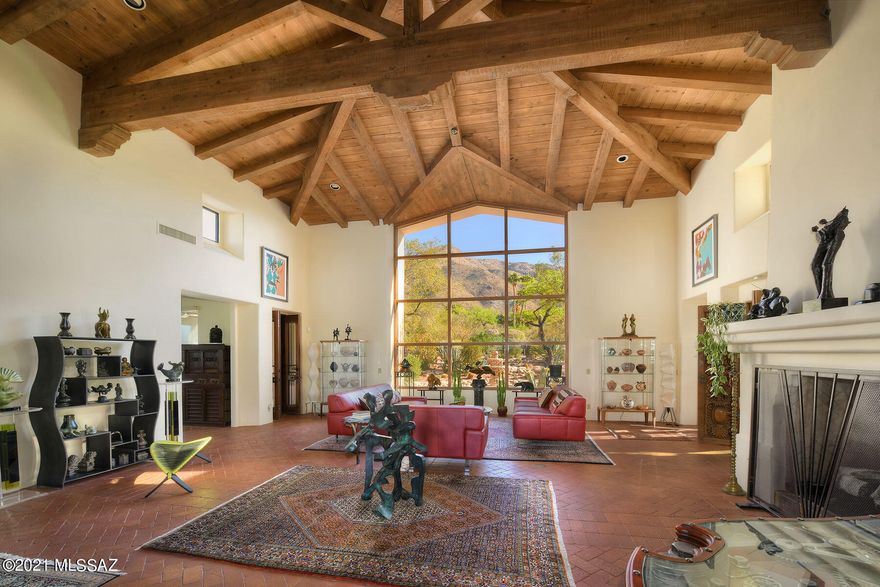 Sellers will accept or counter offers $1,425,000-$1,495,000 for this STUNNING, one-of-a-kind ''Art as Home'' Spanish style masterpiece in prestigious, gated Skyline Country Club w/ reach out & touch the Catalina Mountain views. Gated entry w/ paver driveway leads to courtyard & into great room w/ herring-bone brick floors, soaring GORGEOUS beamed cathedral ceiling, floor to ceiling window framing the mountains, majestic fireplace, carved pillars & circular staircase leading to loft/study w/ walk-out balcony. Lovely remodeled kitchen. Family room w/ fireplace could be 3rd bedroom w/ adjacent full bath & outdoor screened-in family room w/ beamed ceiling. Cantera fireplace, carved doors, unique wrought iron, paved walkways. Words & photos can't describe the BEAUTY of this ONE-OF-A-KIND HOME! Many special architectural features: arches, columns, niches, built-ins, hardware and fountains!  Owned solar (electricity bill in 2020 was $400 total). New garage doors. Upgraded closets. Many rolling shutters/shade screens. Mature landscaping/gardens, intimate covered patios and incredible privacy! All on one level with the exception of the circular staircase up to loft. This home has been meticulously cared for! Truly a "WOW" house...