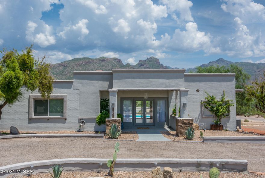 MTN VIEWS GALORE! When you walk into this fully remodeled estate & look through the roll up door overlooking the sparkling pool, you realize what a special home this is! Architectural elements were placed in all the right places to enhance the amazing mountain views. Sunrises will never be the same once you've experienced a morning from this home. Walking distance to Sabino Canyon rec area. Nestled right in the best school district Tucson has to offer! Kitchen has new cabinets and appliances! Beautiful new flooring throughout. Modern and updated! Wess Miller Pirvate park for Hidden Valley residents. Get your feet wet in the creek & enjoy a little bit of the outdoors! THIS LOT IS HUGE W/ENOUGH ROOM TO ADD A CASITA OR GUEST HOUSE ON THE PROPERTY! This home has it ALL! Come see it today!
