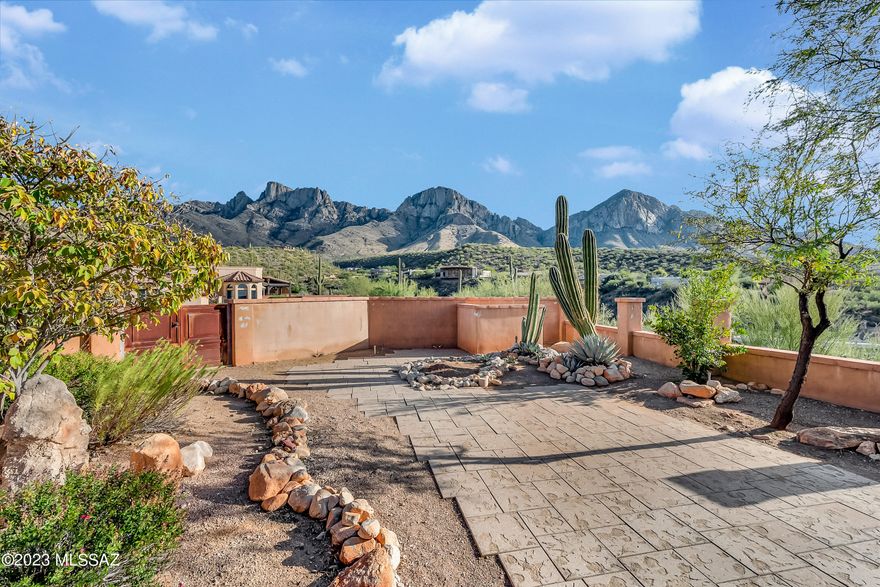Beautiful Mediterranean style home in guard gated Ponticello @ La Reserve.  Sitting high above Oro Valley at the end of a quiet cul-de-sac, this 2 bedroom home welcomes you with a grand rotunda entrance, a den/office, gorgeous wood beam ceilings in the living room, a cozy fireplace, coffered ceilings, Electrolux appliances, Knotty Alder wood doors & trim, & a NEW AC Unit!  Exterior paint just completed!  You'll also have AMAZING VIEWS of the city & Pusch Ridge mountains!  Unwind & relax in the evening with Tucson's best sunsets from your easy care backyard.  All of this and just minutes to dining, shopping, golf, El Conquistador Resort/SPA, medical, & Catalina State Park.  WASHER/DRYER NOT INCLUDED IN SALE.