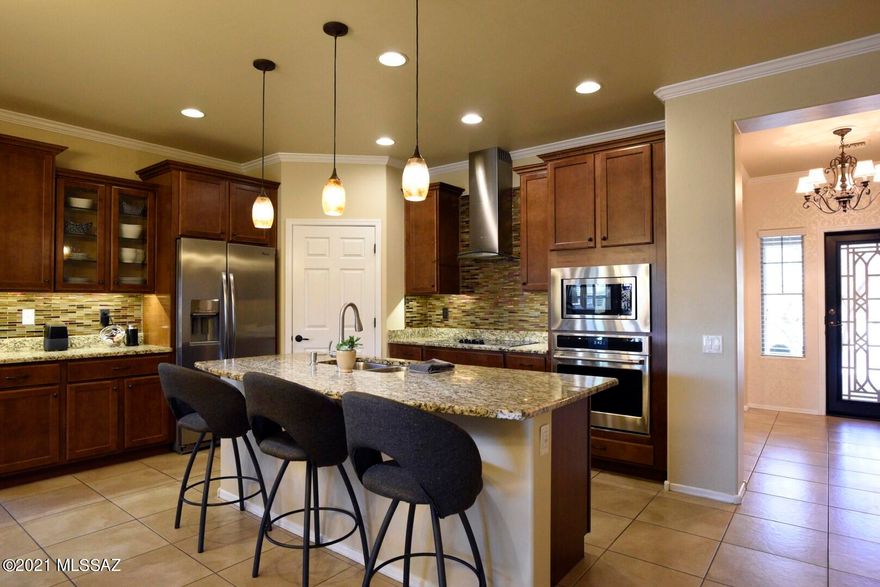STUNNING SIERRA MORADO HOME is a must see! Located in the AWARD WINNING VAIL SCHOOL DISTRICT. 
This breathtaking GEM features 4 bedroom 2 bath with a 2 car garage. SPACIOUS, immaculate, one owner home with open floor concept, high ceilings and extensive upgrades make this home SHINE! Gourmet kitchen features custom metallic backsplash with beautiful granite countertops, spacious island for cooking and entertaining , SS appliances, rich dark cabinets with fused bubble glass doors- custom lighting throughout, Built- in entertainment center, built- in desk, wood floors in (office-den-front room) off entry. 12X12 tile through-out with Berber carpet in master. The back yard is the perfect place to entertain with outdoor kitchen- BBQ area and built-in fire pit. Imagine enjoying the Arizona Sunsets with a glass of wine on this beautiful patio with no neighbors behind you. Solar Panels. Neighborhood parks, dog park, pool, clubhouse, soccer field, and tennis courts nearby.