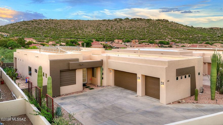 Enjoy beautiful Catalina Mountain views from this contemporary home in a small gated community near Sabino Canyon. The open floor plan features high ceilings, curved walls, travertine floors, and a stacked stone double-sided fireplace that anchors the living area. The kitchen offers maple cabinetry, granite countertops, stainless steel appliances, a walk-in pantry, and a large island. The remodeled primary suite provides mountain views, a spacious walk-in closet, and an updated bath with two separate vanities, walk-in shower, and modern finishes. Three additional bedrooms and two additional full baths provide space for guests or a home office. Step outside to a private backyard with a covered patio, turf area, above ground hot tub and an owned solar system.