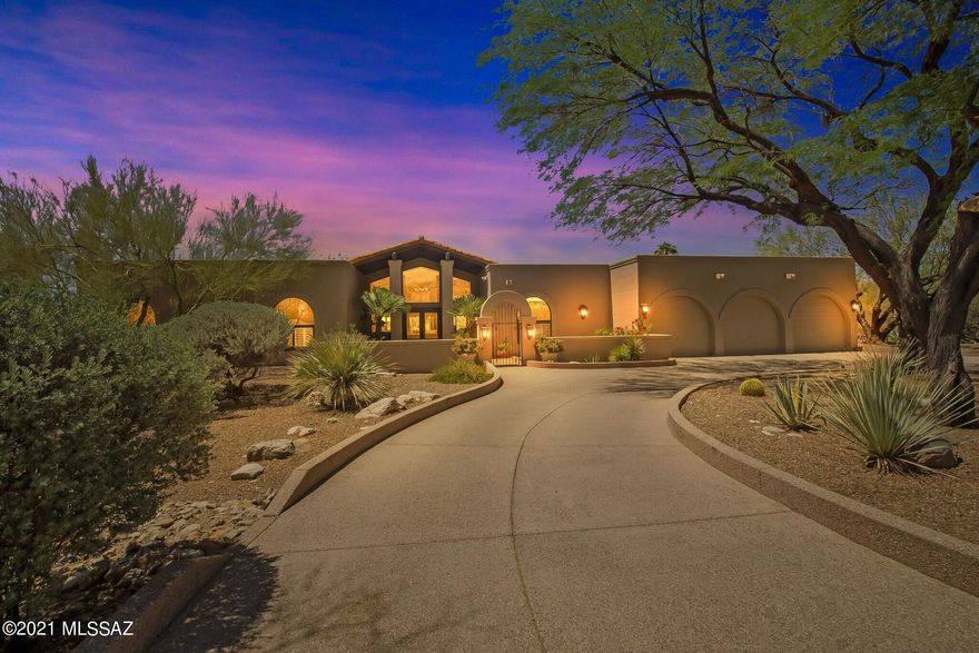 Imagine spectacular sunsets & mountain views. Set in the coveted area of Ridge Estates within the guard gated community of La Paloma. This custom built contemporary home designed by Gary Almi, embraces the Southern Arizona lifestyle. Rich and lush landscape blends with dramatic, open interior spaces. Over a 1/2 acre, and sited North/South, creates strong spatial connection with the surrounding landscape.

Enter the home's welcoming courtyard, one is greeted by a light-filled and easy-living floor plan. The main foyer opens onto the sophisticated living room featuring high ceilings, wood beams, and an expansive wall of windows, with awe-inspiring views of the Catalina Mountains, blurring the lines between indoor and outdoor spaces. Formal celebrations in the living and dining rooms, or casual gatherings in the great room or on the many covered patios, is an entertainer's delight. The chef's kitchen has custom cabinetry, ceasarstone counters, center-island, walk-in pantry & appliances for the gourmet cook. Primary ensuite showcases beautiful custom cabinetry, walk-in closet, oversized walk-in shower & private entrance to backyard

Entertain in the expansive backyard, with built-in gas fireplace, covered Ramada with custom awning provides plenty of shaded outdoor living space. 

This location places you close to the finest restaurants and shopping. With easy access to all there is to see and do in Tucson.