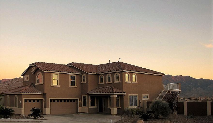 VIEWS! Beautiful 5Bedroom with spectacular views of the Catalina Mountains & city lights. Graceful elegance greets you at the tile mosaic entry, past the Piano Room & Formal Dining into the Living Room w/ vaulted ceiling, & gas fireplace. A Chef’s Kitchen w/ cherry cabinets, granite counters, SS appliances, double ovens. The 1st floor Guest Room is located next to a full bathroom. The 2nd floor (w/upgraded stair/loft banisters) has 4 large BRs & loft. Upgrades include extensive exterior/interior lighting, window coverings, cabs/counters in bathrooms/laundry.A custom deck runs full length & delivers the best views in Tucson. Tiled patio, storage room,& palm trees/citrus add to the oversized lot. The 3car garage has epoxy floors, custom paint & central vacuum. Not your average home-must se