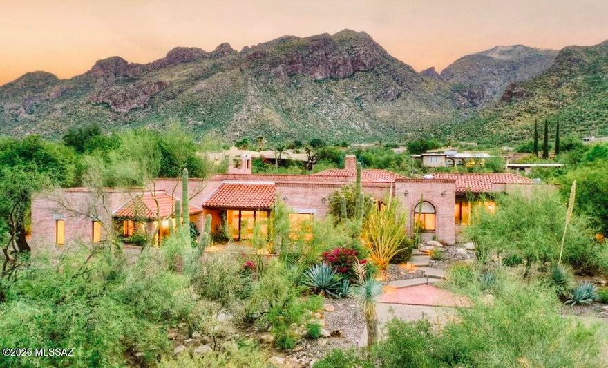 With majestic mountain and city views, this stunning estate was timelessly designed by Ron Robinette in the exclusive guard-gated community of Rancho Sin Vacas Estates. The slump block/brick construction exudes quality, character & authenticity. Resort-like living with expansive covered patios & multiple courtyards, heated pool/spa, two outdoor gas fireplaces, nearly an acre of lush desert landscape, and stunning sunsets w/city lights. Discover an enchanting interior with soaring ceilings, bright skylights, hardwood flooring, exposed beams, and inviting gas fireplaces in both the living and family rooms. The oversized kitchen showcases quartz counters, abundant shaker cabinetry, custom stone surround with high-end SS appliances, including a gas 6-burner + griddle range, double ovens and Sub-Zero fridge and freezer. A surprise hidden walk-in butler's pantry with an additional sink and fridge, as well as an expansive island with a breakfast bar will make this the kitchen of your dreams. The serene owner's suite boasts multiple enclosed patios with views, a private bathroom with dual sinks, a soaking tub, a raindrop shower, and two walk-in closets. Large guest rooms w/en-suites and walk-in closets. You'll also find a versatile bonus room that opens to the back patio. Create lasting memories in the backyard featuring covered patios, travertine pavers, a heated pebble-tech saltwater pool and spa with in-ground cleaning system, artificial turf, and scenic vistas. 3 car garage + air-cond Bonus Rm + Wkshp + built-in cabinetry galore. Major improvements in 2022 include two new AC units, all new water heaters, new roof coating, new plumbing fixtures, new water softener, and numerous cosmetic updates throughout the home. The owner/seller is a licensed realtor. This gem is a true find!