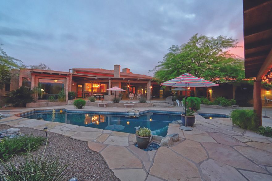 GATED LUXURY AND STUNNING CONTEMPORARY EASTSIDE ESTATE on over 3 acres. Conveniently located near Houghton and Broadway and very close to miles of hiking trails. The quality of the construction of this home will make you proud to be the owner, finest of materials and workmanship. Main home is 4302 sq. ft. and GUEST HOME is 1245 sq. ft. The elegantly covered patios are well designed to capture the best of the day and night with multi views and convenience to the inviting pool. The enchanting gardens and meandering walkways, bridges, and 2 outdoor fireplaces gives it the feel of a mansion. With built in BBQ, pebbletec Pool/Spa and Mountain views. Greatroom with Stone Fire Place, Flagstone floors and Gourmet Kitchen, open concept, Vega Beams and sauna in master bath. A true Diamond