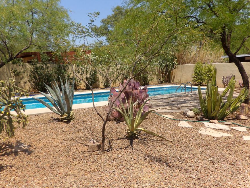 Located in central Tucson, this lovely 1950's bungalow has exactly what you're looking for. Small and quaint let's call it home. Large fully landscaped front and desert rear yard surrounded by a block wall and wrought iron fence and gate. Back yard features a smaller sized lap pool, 4 feet deep which means lower maintenance. Enjoy your day or night in a relaxing outdoor side patio garden that features a small waterfall. Back yard also includes a covered patio connected to a large workshop/laundry room. Saltillo tile floors throughout. 1 bedroom and office or 2 bedrooms, your choice! Some deferred maintenance, bring your tools. Patching, paint and some updating will make this the perfect home. Priced accordingly. Come check out this property today!