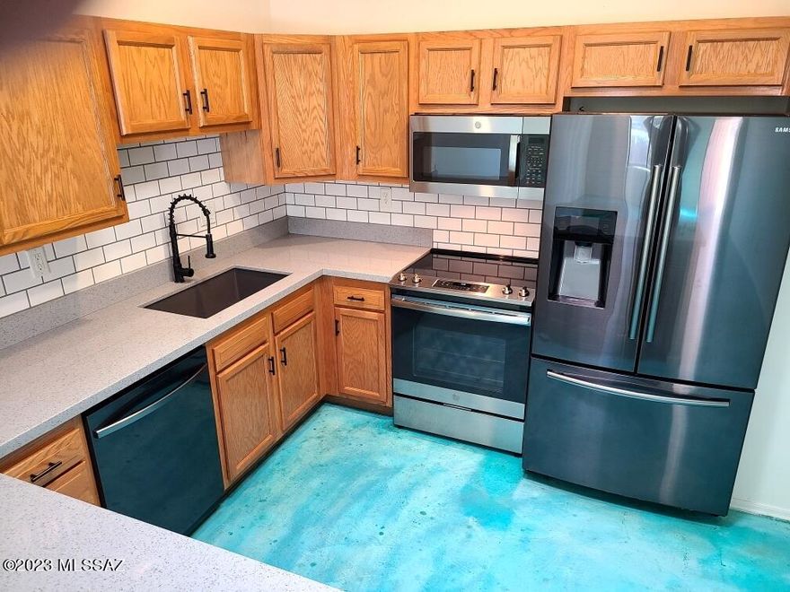 Charming Barrio Escalante, 3 Bed/2 Bath Townhome with 2 Car Garage!! Freshly Painted  Great Room Plan with many upgrades. *Artistic hand painted concrete flooring *stainless steel appliances  *High Ceilings *Recessed Lighting *4 skylights *2 Sliding Glass Doors *Scenic Catalina Mountain Views *Quartz Counter Tops*Spacious Kitchen w/ Pantry *Lengthy Breakfast Bar *Bathrooms feature Marble Countertops*Small private yard *Laundry Room w/ Cabinets *Ceiling Fans all Room Path. Hurry... Tucson Townhomes with Low HOA dues + 2 Car Garage are rare finds!