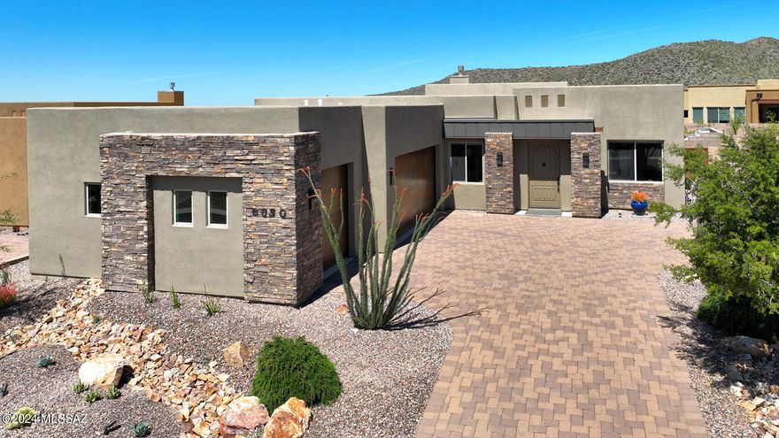 In the heart of Dove Mountain, luxury living merges effortlessly with the surrounding nature and abundant recreational amenities.  This fabulous 3 bedroom + den, 3.5 bath Miramonte Home is located in the highly desirable Boulder Bridge Pass gated community just minutes from the Ritz Carlton and world-class golf and hiking.
 
The open and airy layout provides a seamless flow from room to room, perfect for both everyday living and hosting gatherings. The exceptional and tasteful design choices and attention to detail are evident throughout, with an expansive open kitchen that flows into the family room for an amazing entertaining and family space. The kitchen features an abundance of cabinets, a double island/bar, island prep sink, granite counters, glass tile backsplash and a neutral organic color palette. Outside, a resort-like oasis unfolds, featuring a beautifully designed heated pool, spa and waterfall, travertine patio, see-through iron fencing, and built-in gas firepit with benches, making this space ideal for both relaxation and entertaining.
 
Additional luxuries: High ceilings throughout home, upgraded interior doors, high-end ceiling fans and light fixtures, gas fireplace, all suggest attention to detail and a focus on both aesthetic appeal and functionality. The upgraded wool carpet in the 3 bedrooms adds a touch of luxury and comfort.
 
The 3-car garage with epoxy floors, water softener, garage shelves, and tub sink offer practicality and convenience. Exterior landscape lighting and the recently updated desert landscaping add to the ambiance and enhance the property's curb appeal, especially against the backdrop of the desert's natural beauty.With fresh paint both inside and out, the home is not only visually appealing but also well-maintained. Overall, this Miramonte Home at Boulder Bridge Pass presents a rare opportunity to experience desert living, where luxury, comfort and functionality seamlessly merge amidst breathtaking surroundings and world-class amenities.