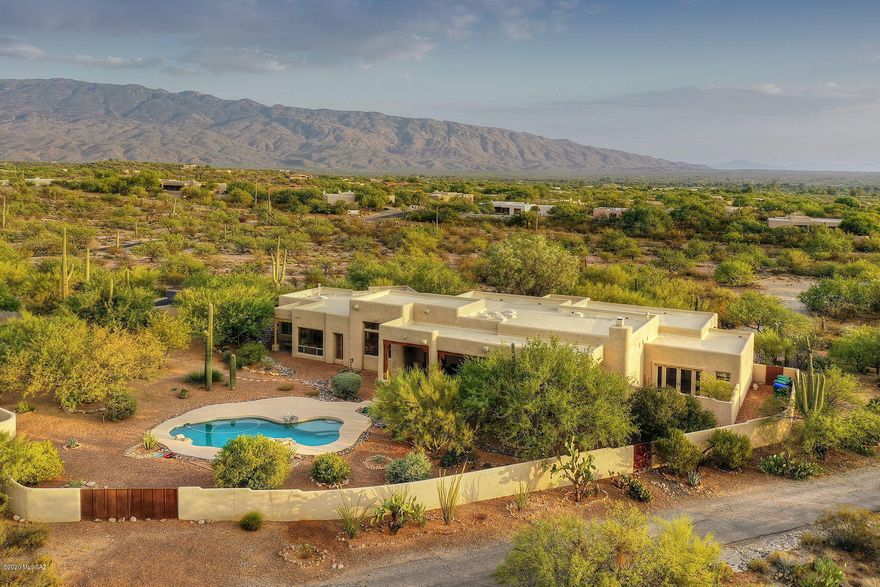 Welcome home to your custom built 3751 sq ft desert dream home. Enter through a private gated entrance down your paved drive to a welcoming front courtyard. Inside ample natural light & beautiful architecture abound. Soaring ceilings with exposed viga beams, columns, arches, and niches throughout. Retreat to your private master suite with adjoining patio or find sanctuary in your studio/office carefully placed at the end of the home for peace and quite. Bedrooms 2 & 3 are set up for independence with their own study/play room and a full bathroom with double vanity. No detail was forgotten from Smart features, to extra storage. Sit under your large covered back patio & look out at your 4 acres enjoying the mountain views, lush desert landscaping, or take a dip in your sparkling pool.
