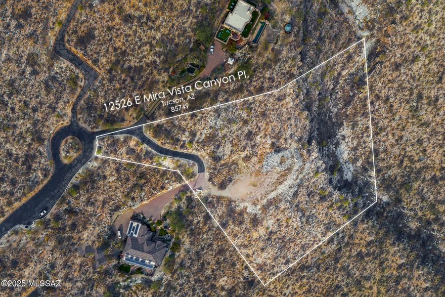 Exclusive 3.3-acre lot in the gated Mira Vista Estates community is positioned with a coveted North/South orientation & offers captivating sunrise & sunset views over the city-scape & surrounding mountains. Easy access via a fully paved road, this private & tranquil lot is situated at the cul-de-sac's end & is adjacent to a small canyon. A prepared house pad provides a level build site, ALL essential utilities saving you valuable time, money, & effort. This is your unique opportunity to craft your dream home in an exclusive Tucson community in the Tanque Verde School district. Contact me today for more details or to schedule a showing.