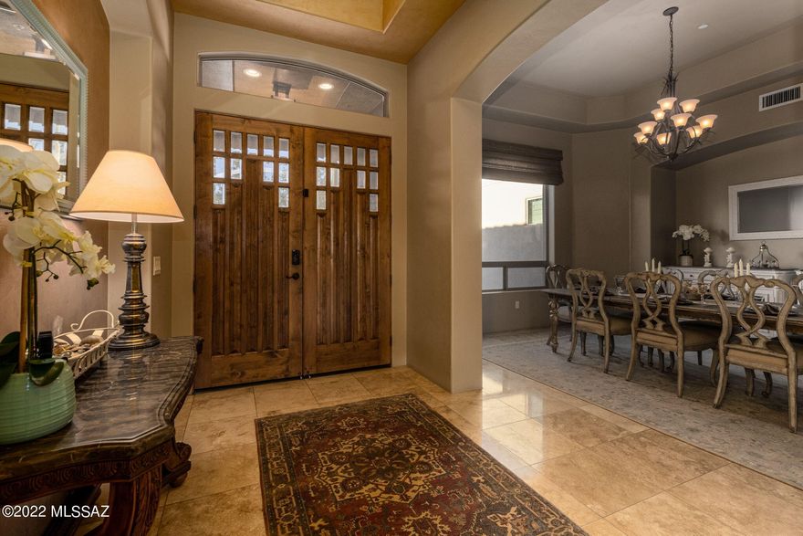 This fully furnished 4 bed, 4.5 bath, 4 car garage home located in the highly desirable Dos Lagos at Dove Mountain subdivision is a buyers dream. Indulge in complete luxury with stunning upgrades inside and out. Greets you with high ceilings in the entryway, formal dining room and spacious living room. These lead to a large open kitchen with large pantry, double ovens, commercial size refrigerator, and dining space. Step outside into your own private oasis featuring a cozy gas fireplace, mounted TV, and experience ultimate comfort in your Tropitone outdoor furniture. Completely shaded with retractable awning and misting system for those hot days. Fully remodeled pool, 2 spas, and outdoor kitchen with all new appliances, weather proof TV, and sound system. The attached 3-car garage contains plenty of storage along with a detached garage that has a climate controlled/dust-free storage room and state of the art golfing simulator. This home is truly a one of a kind property! (See additional list of additional upgrades in documents).