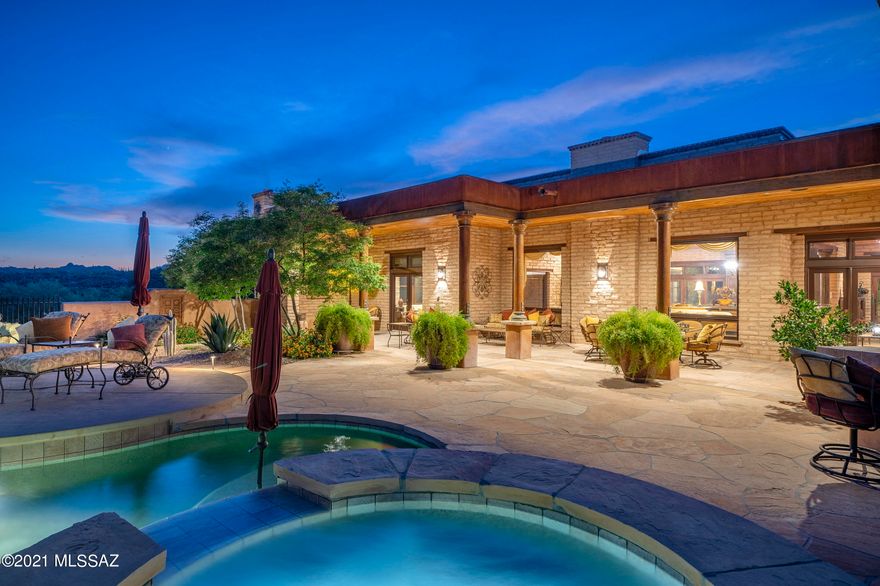Located in the highly sought after community of The Estates at Honeybee Ridge. Set high on a premium view lot, this home is nestled within the lush natural desert landscape,  adding to the secluded feel of this estate property. An elongated veranda connects the shared living spaces, with a series of glass doors coordinated to tie the interior rooms to the spacious outdoor living environments, resulting in a perfect  juxtaposition of private and social spaces.Layers of covered patios are perfectly situated to enjoy year round, with views stretching out over Pusch Ridge and the Catalina Mountains beyond. Native vegetation provides a seamless background to the manicured grounds causing an explosion of color, light and shadow. Upon entry, you are greeted by a large "Great Room" with soaring ceiling heights acting as the central hall, inclusive of the formal living room to one side and dining, kitchen on the other, establishing the main connection point of the home. The private East wing of the residence features the sumptuously appointed owner's suite, with custom dressing closet and a luxuriously finished bath, including a large walk-in shower and soaking tub.

The floor plan comprises both formal and informal living spaces, equally suited for grand entertaining, as well as quiet moments, with a chef's kitchen where every measurement and detail has been carefully considered, boasting an oversized custom center island, designed to appear as furniture, complete with top-end fit and finish, including a La Cornue Grand Palais 180 range. Almost 6 feet in length, this handcrafted detail of absolute perfection is the crown jewel of the La Cornue | Château Series, commanding respect and admiration in any kitchen.

This very private lot offers a series of patios and exterior living spaces designed for outdoor entertainment. The SW covered patio offers an outdoor kitchen, complete with a barbecue station, gas cooktop and sink with endless counter space and bar top. The veranda incorporates a masonry fireplace and covered dining patio, perfectly designed to the home's effortless blend of laissez-faire.

A succession of courtyards results in varied focal points, unwinding like a garden narrative of texture, light and mood. Every comfort considered and detail meticulously crafted, results in a home that offers a sense of easiness to enjoy both lifestyle and entertainment. 


About the Area:

Honeybee is rich in Arizona History. The canyon that borders the west side of the development is called Honeybee Canyon. According to archeologists that have studied the area, the Native American Hohokam Indians discovered this area and were using Honeybee Canyon from the earliest of times.

Honeybee Ridge is a unique development consisting of 128 Custom Home Sites. The development is smaller than most of its competitors. No resorts, no high-density development, no golf courses, just a nice, quiet, peaceful place to enjoy Arizona living.

The Estates at Honeybee Ridge encourages its residents to be creative with high-quality materials and designs that are conducive to our wonderful landscape. When the development is complete, 128 custom homes will be built, all homes will be single-story, lot sizes are a minimum of one acre and design guidelines limiting disturbance to 16,000 feet per lot (not including driveway) will keep 75% of the development pristine & untouched.