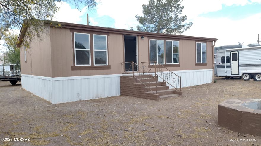 Very nice and updated 3 bedroom 2 bath manufactured home in Southwest Tucson.  Great floor plan with living, kitchen & dining areas.  Kitchen includes, stainless electric range & double door fridge. Nicely updated baths, new water heater & new AC. New roof recently installed.  Home is ready for new owner/s. 
Outside trailer does not convey & will be removed.