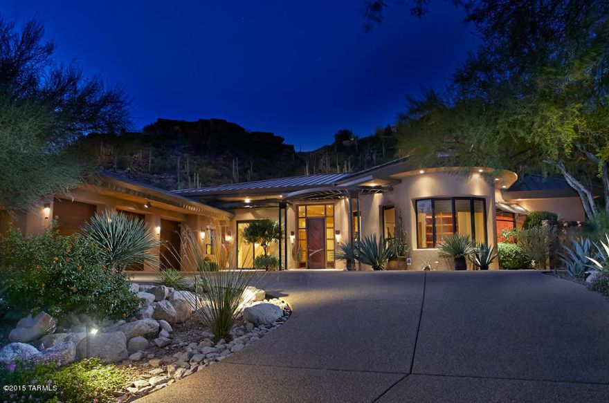 A stunning architectural masterpiece in Ventana Canyon C.C Est. nestled into a 1.2ac saguaro studded lot to provide views & privacy. Enter through the custom metal front door into the grand liv.rm w/floor to ceiling walls of windows, wood planked ceilings, custom built-ins, travertine floors throughout & an elegant dining rm w/bar. The epicurean kitchen features granite counters & backsplash, high end appliances & a butlers pantry. Mstr bdrm wing features a luxurious bathrm w/steam shower, 2 closets, Jacuzzi tub & private office w/custom built-ins.  3 spacious guest rooms, Stunning bathrms & designer finishes are found throughout this home, all on one level w/NO steps- a rarity in Ventana! Lush desert gardens, pebbletec pool/spa & built-in grill make for an entertainer’s outdoor paradise