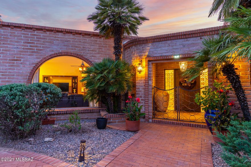 Classic Tucson Country Club burnt adobe situated on a .54-acre lot in the coveted Tucson Country Club Estates. Welcoming courtyard entry and a bricked circular drive lead to architecturally pleasing details within this Territorial home. Inviting foyer overlooks an expansive backyard complete with green grass, mature trees, and an inviting covered patio with Adobe arched accents. Entertaining will be a delight with so many spaces to gather and enjoy. Interior features attractive an extensive Mexican tile flooring, French doors, Talavera tiled bathrooms, a warm natural palette, and ample natural light. Spacious living room is accented with both an impressive southwestern Adobe gas fireplace, and a large arched picture window. Open kitchen features a commercial style six burner range with a stainless-steel hood vent, beautiful Talavera tile counters, nook and picture window overlooking lush backyard. The community boast fantastic family-friendly opportunities, like picnics and parades to block parties and strolling. Come see what you are missing! This section of the community is not a part of the homeowners' association.