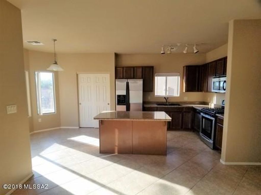 This gorgeous 3bd/2ba 2 Story home is located in Desert Stone and in the Award Winning Vail School District. Home boasts great room, dining room, eat-in kitchen with separate living room/family room. Large loft and bedrooms upstairs. Washer/dryer included in home. Covered back patio opens to a catty cornered large lot with a fenced in conventional swimming pool. Neutral color throughout home, downstairs tile with tile in the bathrooms and laundry. Large master suite. Master bath has dual sinks, stand alone shower and large walk-in closet.  House is available for immediate move-in. Pets upon Owner Approval only!