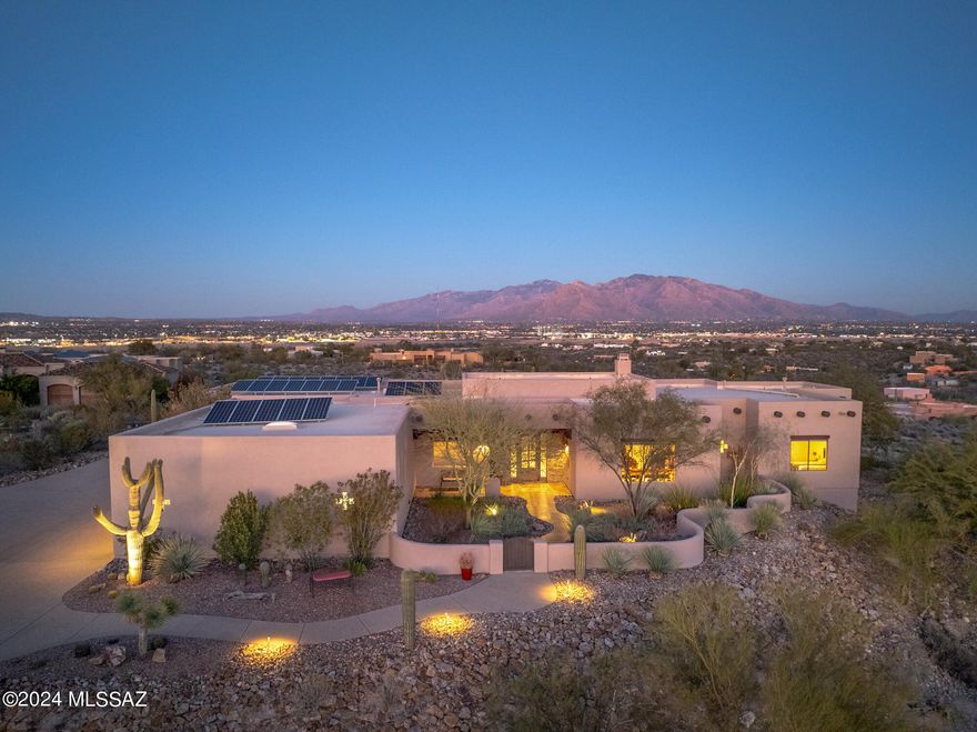 Views! Views! And More Views of Tucson Valley and mountains are a couple features of this amazing home! Nestled on 3.3 acres in the gated community of Tucson Mountain Reserve, this property offers resort style living with privacy and comfort. As you step through the custom wrought iron & glass door, you'll see over four thousand square foot of living area that has views in almost every area of the home. This Santa Fe inspired home has high ceilings with exposed wooden Viga beams comes with 6 bedrooms, 3 full bathrooms, an oversized 3 car garage, formal dining area, breakfast area, and an open floor plan that connects the kitchen with the living area. The Chief's kitchen has a large center island with quartz countertops, lots of cabinet space for storage, wine fridge, and comes with all stainless steel appliances including a subzero refrigerator & Wolf gas range, hood, and double oven. There's no carpets throughout the home. All the 6 bedrooms have porcelain tile installed and one of the bedroom has a wall bed that conveys. The primary bedroom is very spacious with 2 walk-in closets, its own fireplace, exposed beams, access to backyard, large shower, and a corner soaking tub with views! With many rooms, one can make a room an office, home gym, wine cellar, or guest rooms.
  	One of the best features of this home is the backyard. Push the folding patio doors together to have a space that the outdoor and indoor flow seamlessly. This backyard is an entertainer's paradise! It includes multiple outdoor kitchens with gas & wood / charcoal grills, an outdoor wood pizza oven imported from Portugal, built in ice chests, 4 copper natural gas firepits, large seating areas, and a negative edge pebble tech pool with spa that will be perfect for get togethers with family & friends at any time of the year. But most importantly, anyone there will see that the backyard area offers the most beautiful panoramic mountain views or at night, a lit up city full of lights! Current owner spared no expense on property with landscape upgrades includes purchasing 19 saguaro cactus to add to the land with now over 49 saguaros all together, purchase solar system since 2016 that hasn't had an electric bill since, had the outside exposed Viga beams capped in copper plating, new epoxy floors in garage, and just got the whole outside painted just to name a few. The pride of ownership shows! A once in lifetime opportunity to be the homeowner who gets to see these majestic views of sunrises and sunsets on either sides of the house, live in an amazing community, and have easy access to I-10. Come see today!! AND ask about a twilight showing.