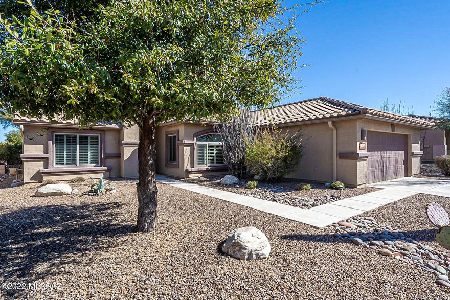 Located in desirable Quail Creek Country Club, a gated community by Robson. Expanded  Laredo floor plan with bay windows in both bedrooms, plantation shutters throughout.  Has a great room with split bedrooms & den. Includes a full patio with ceiling fans, beautifully landscaped walled yard with mature landscaping and a fountain. Garage is extended in length and also in width. Built-in garage cabinets, workbench, utility sink and epoxy floor.  Are you ready for your new home?