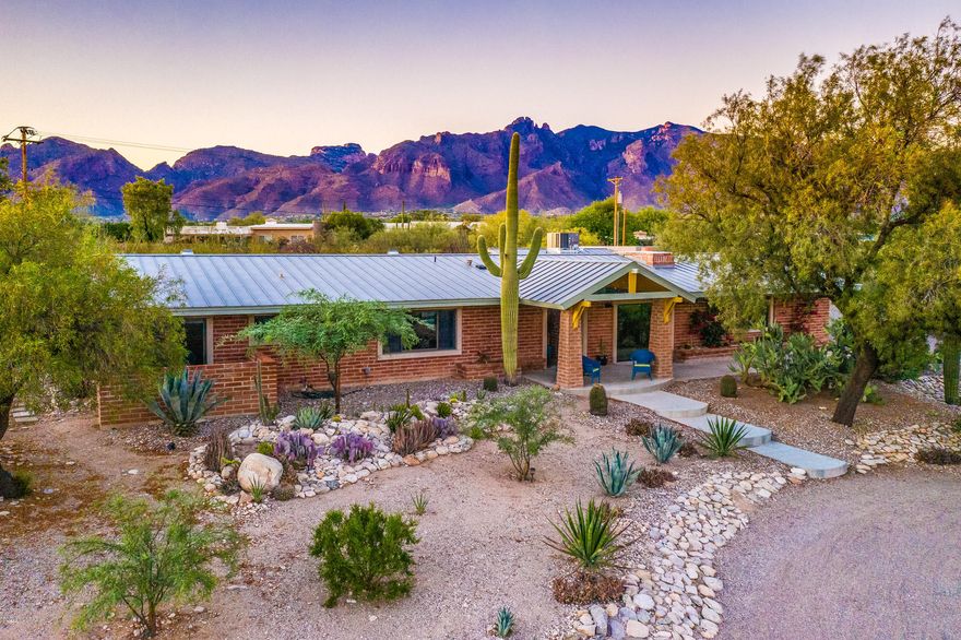 The best desert living! Beautiful & stylish MID-CENTURY modern home with city and mountain views. District 16 schools and fabulous Catalina Foothills No. 5 neighborhood. Walk or bike to the best restaurants & shopping in Tucson. Easy commute to downtown & UA.  Fantastic, updated 3 bd/3ba main house w/modern kitchen and breakfast bar opening into great room w/FP; original Master Suite AND NEWER Large Master Suite with spa-style bathroom; beautiful vaulted ceilings; polished concrete floors; extra-deep 3-car garage with workbench; new outdoor entertaining ramada with wet bar, stools, built-in grill & refrigerator; hot tub. Sleek new guest house 1 bed/1 ba with stunning interior, private patio and mountain views. Primed desert entertainment AND relaxation. You will love this house! MUST SEE! 5611 North Mina Vista upgrades since Feb 2015:

Guest house/Casita - full house, brand new 575 sq ft.
3-car garage with workbench and cabinets/storage
New concrete floors throughout
New larger sliding glass door in front
New slider in dining area
New masonry wall surrounding back yard
Kitchen redesign with new counters, new window and snack bar, new refrigerator
Many new light fixtures
New ac in 2018
2 hot water heaters
Mini split air in master bedroom
Sprinker system installed
5 new mesquite trees and many new plants
Plumbing upgrade
Fan in smaller bedroom
Some new pool equipment
New turf grass
New brick pillars throughout back patios.
New outdoor bar & grill with refrigerator and sink and stools
New metal gates and concrete paths outside near pool area
New private patio and modern steel fencing behind guest house
Hot tub and decking