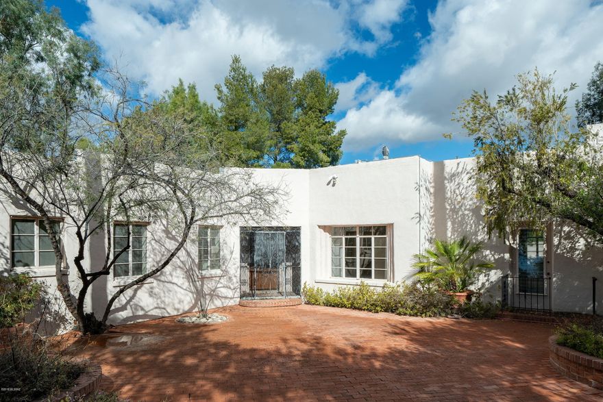 This is your chance to live in Historic El Encanto Estates. This centrally located home has been owned by 1 family since 1976. Over ½ an acre, 5 bedrooms and 4 bathrooms and 4433 square feet.  Home has many classic/unique features such as a large brick courtyard entry, butler's pantry, shaker cabinets and an indoor exercise pool added during 1977 remodel.  HVAC replaced approx. 2014. Backyard pebble-tec swimming Pool in a private enclosed yard. Up the outside staircase to an artist studio.  2-car garage and additional workshop. Close to U of A, Botanical gardens, shopping, medical facilities and downtown.