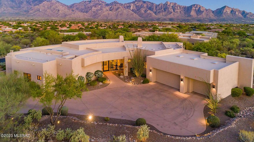 Panoramic Catalina Mountain views! Award winning architect, Kevin Howard designed 3BD/4BA/Den/Media Room (4,256 sq ft) estate on an elevated acre lot, with city light views, in the private, guard gated Estates at Honey Bee Ridge.  This resort-style home, w/ rare to find craftmanship throughout offers great room w/ fireplace, guest bedrooms w/ private baths, travertine floors, 900 bottle wine cellar, spacious laundry room, private office, media room and views in every room.   Chef's kitchen w/ dual islands, SubZero fridge, granite counters, 2 D/W, 2 ovens & 6-burner gas cooktop.  Spacious owner's suite w/ fireplace, luxury bath & custom closet.  Backyard oasis w/ expansive covered/uncovered patio, large grill island, saltwater pool w/raised spa, professional landscaping & views! A must see