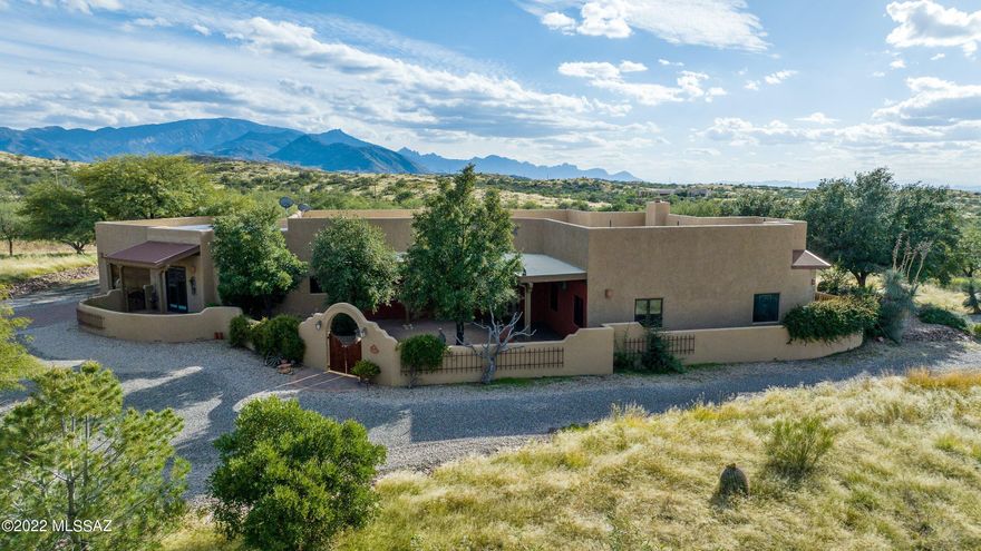 LARGE price improvement on this SPRAWLING custom estate on 3.3 acres (horses allowed) bordering state land! Two BRAND NEW TRANE HVAC units and custom touches at every turn. Gated entry with impressive driveway leads to a charming private courtyard. Situated at the rear of the lot, the views are as impressive as the home itself. 2900+sf of single story living plus 900+ sf Arizona room will make you never want to leave. Split bedroom floorplan provides privacy for all, and of course the heart of this home is the magnificent kitchen, complete with Viking stove, custom island and walk-in pantry. Oversized 2+ car garage and workshop area are a bonus. Outdoors you will find a Kiva fireplace patio, potting shed and freestanding workshop. Granite boulders dot this flat and usable lot. Located an exclusive enclave of homes in Oracle, this one-of-a-kind homestead will steal your heart.