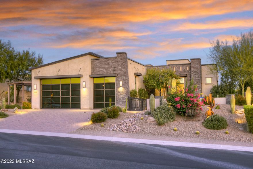 STUNNING TOLL BROS ''MODEL'' HOME- EXQUISITE  DESIGN  NESTLED IN ''RESORT'' AREA OF DOVE MTN- ENJOY GOLF COURSES, RITZ CARLTON RESORT, HIKING/BIKING TRAILS , SAGUAROS/ROCK OUTCROPPINGS/MAJESTIC MTN RANGES...CREATE MAGICAL RETREAT! TRULY ONE OF A KIND...''MODERN'' ELEVATION-  GLASS GAR DRS/ EBONY STONE & METAL ACCENTS BRINGS  INDUSTRIAL FLAIR!  MAGNIFICENT ESTATE...GRAND ENTRY/ SOARING CEILINGS, GATHERING RM OFFERS VANISHING WALLS OF GLASS -  TO GLORIOUS BKDYD! ENJOY TUCSON'S OUTDOOR LIVING... HEATED POOL, INFINITE  SPA W/ DRAMATIC WATERSPILL & OPEN FP, METAL PERGOLA- ALFRESCO KIT/BBQ DINING AREA...EVEN A PUTTING GREEN/ SANDTRAP! FILLED W/LUXURY FEATURES...INTERESTING ARRAY OF STONE & UNIQUE TILE DESIGNS, CHEF'S KIT-SS APPLIC, BLEND OF  GRANITE/QUARTZ & WOODS, *FURNISHINGS AVAILABLE*