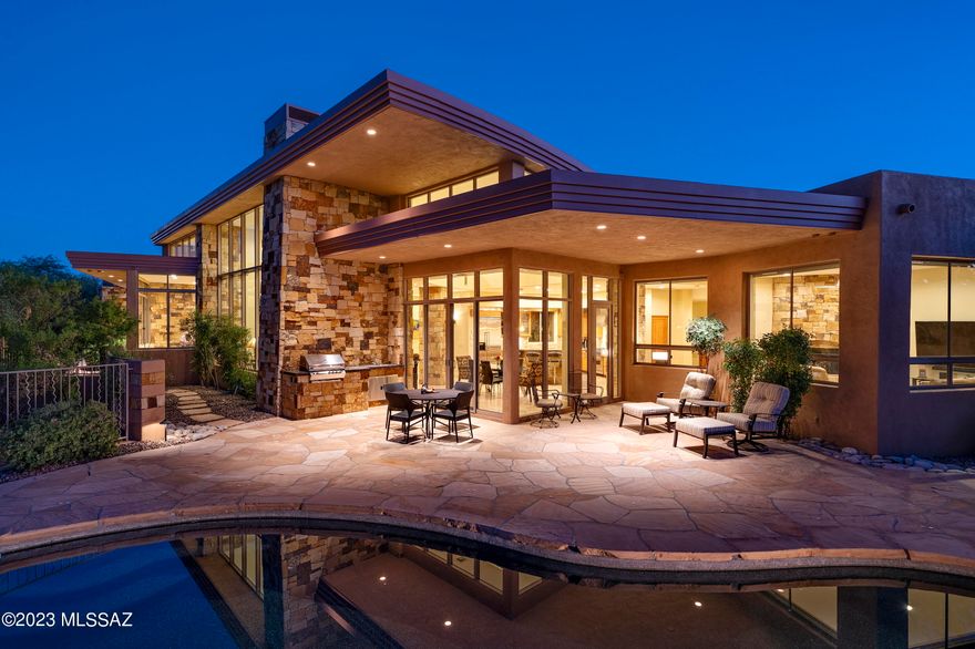 Beautifully designed contemporary home featuring walls of windows showcasing expansive stunning mountain views. Open split floor Plan, 3BR plus Den/Study. 24' travertine flooring, stone accents, alder wood doors, high ceilings and an abundance of natural light. Wonderful open gourmet kitchen w/Viking appliances, island bar, gas range and cherry wood cabinetry. Spacious primary suite features picturesque view of the mountain, custom designed walk in closet. Private outdoor resort like backyard with entertainment area featuring pool, spa and built in bbq area and fire pit. Designed by Tucson architect Bill Gansline.
