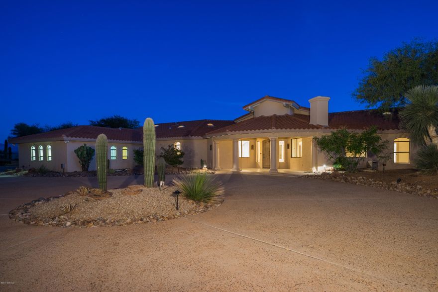 Mediterannean design is the inspiration for this incredible gated estate in the heart of Green Valley! Almost three acres with Santa Rita Mountain Views from every room! 5400 sq ft of luxury is comprised of 6 bedrooms, 7 baths, a pool house and a seperate guest casita. Lush desert landscaping and a circular drive frame the grand entry. Floor to ceiling windows with breathtaking views of the mountains greet you upon entering this spectacular home. The palatial great room showcases soaring wooden beamed ceilings, an entertainment bar, a roaring fireplace, seperate gaming area, and elegant dining room. The gourmet kitchen is nothing short of amazing with its sub zero fridge, granite counters, seperate ice maker, gas cooktop and VIEWS of the mountains everywhere you turn. A spacious den  is conveniently located off of the great room and boasts its own fireplace. 2 more bedrooms with ensuites graciously accommodate your growing family or all of your winter visitors! The master suite is an opulent retreat with its grand space, awe-inspiring views and spa-like bath. Stepping outside is an unforgettable experience in this home! An expansive patio overlooking the pool and mountains is the perfect setting for family, friends and memorable events. A pool house and seperate guest casita add to the welcoming ambience. If your dream is a magnificently impressive home in a completelty private and tranquil setting, then "Welcome home"!
