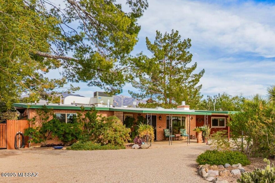 Own a rare piece of Tucson history in this 1958 double wire-cut custom brick home located in the heart of the desirable Laurel Addition Community. Offering 4 bedrooms and 2.5 baths on nearly ⅓ acre, the home blends thoughtful modern updates with timeless mid-century character. Enjoy Catalina Mountain views from the expanded covered patio, relax in the 24' saltwater pool and spa, and tend to a 1,200 sq ft irrigated garden supported by 2,500+ gallons of rainwater harvesting. Sustainable living meets classic Tucson charm with a chicken coop, natural gas BBQ, and a 600 sq ft garage with workshop and storage, a truly special midtown opportunity. This home is loaded with features and upgrades (see document). ***Here is your chance to own a piece of true Tucson history and it won't last long! **