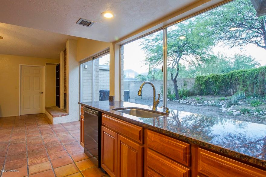 Move-in and have a party!  Every room has a view, mountains, vegetation, cool pool.  Bring the kids, bring the dogs.   Great house, great location. Great price! Newer kitchen, saltillo tile & new carpet throughout. Open  flooplan, family  room with fireplace, large walled yard with great vegetation, mountain views and a cool pool. Newer electrical upgraded panel, cold A/C. This wont last long.
This area is sought after, close to shopping, schools, restaurants, Udall park, Sabino Canyon, you just can't lose.  Over one half acre, you can actually stretch out and enjoy your privacy .