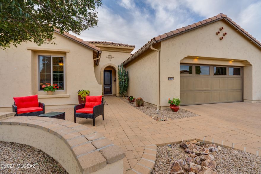 Bold, yet timeless updates in this gorgeous home located on a wash with MOUNTAIN, CITY LIGHTS, WASH & SUNSET VIEWS!   Architectural details are abundant in this 2 En Suite bedroom home that boasts a spacious den (w/double doors) an expanded dining room, an oversized laundry room (w/ sink), a craft area & a powder room.  With views of the wash from most rooms, you will enjoy entertaining inside & out.  A cook's kitchen w/upgraded cabinets (lots of pull-outs), granite countertops, custom backsplash, an RO system at recessed sink & gorgeous upgraded 42'' cabinets.  Tile throughout home & plantation shutters!  Garage:  custom built-in cabinets, water softener, extended garage & tandem golf cart garage, overhead storage.  Paver driveway.  PREPAID SOLAR LEASE.  Electronic screens on rear patio! Dimmer switches on most lights.  Retractable front screen door.  10 years left on prepaid solar lease.  Low care landscaping.