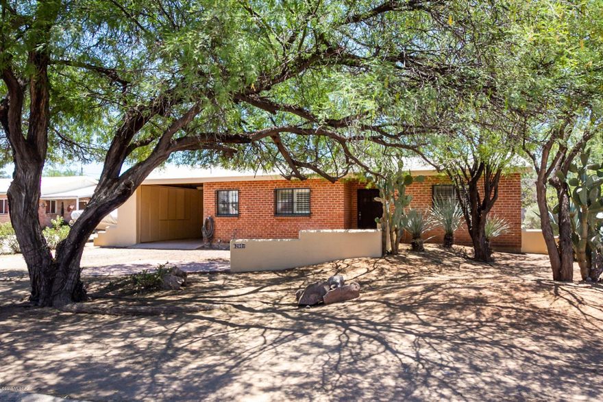 Split 3BD/2BA designed double brick home, open and airy living room with brick fireplace. Double Glass doors lead to enclosed rear patio and huge back yard. Perfect for RV/boat storage or pool. Bright kitchen with lots of counter/cabinet space. Separate pantry/utility room with veggie-sink and dishwasher. Master bedroom has vaulted ceilings, walk-in closet w/built-ins. Single carport also offers cabinet storage. Freshly painted inside and out. Plantation shutters on all windows. Large laundry room. NO HOA! A/C and Hot Water Tank replaced in 2017. Motivated seller! Close to everything, malls, shopping and restaurants. Plus 2-10 home warranty. Professional pictures soon