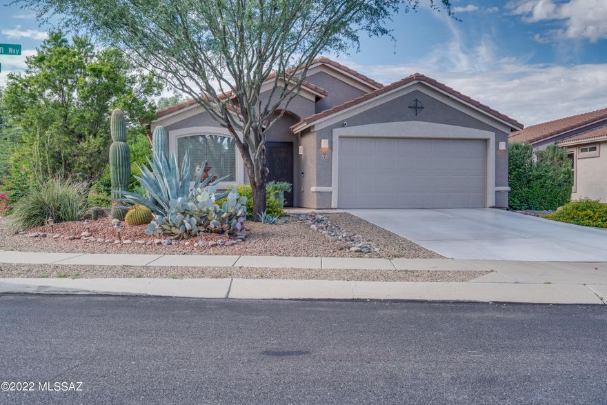 Stunning 4 bedroom, 2 bathroom home in Oro Valley with mountain views! Curb appeal galore as you approach this corner lot with its very own fountain in the front yard. Large windows and vaulted ceilings make the open space feel bright and inviting.  The open concept kitchen allows for easy entertaining, while the primary bedroom gives you ample space  and privacy to unwind. The primary bedroom and bathroom features a large walk in tub and separate shower, double vanity and walk in closet!  Just outside of the back door, your own personal oasis awaits. Mature fruit trees, gorgeous mountain views, a covered patio and extra space to plant your own garden, this could be the backyard of your dreams. Come see this stunning home!